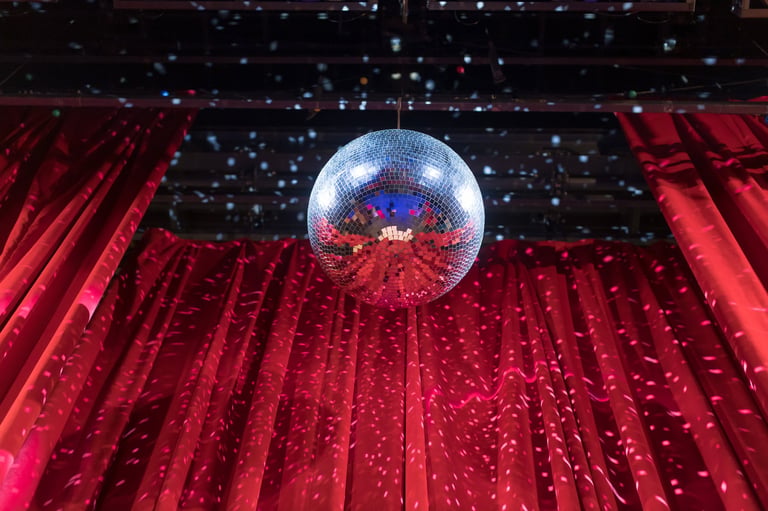 Disco ball reflecting light in vibrant venue
